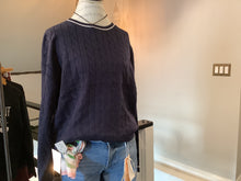 Cable knit navy sweater with white accents